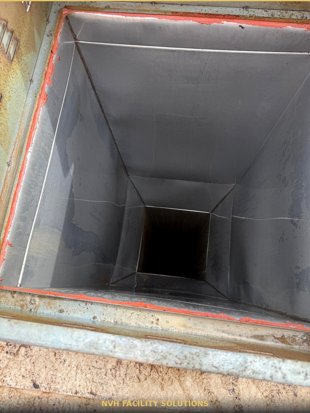 Interior of a grease duct cleaned back to bare metal after high-heat pressure treatment
