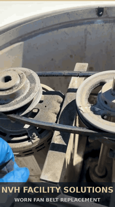 A heavily worn exhaust fan belt inspected before replacement