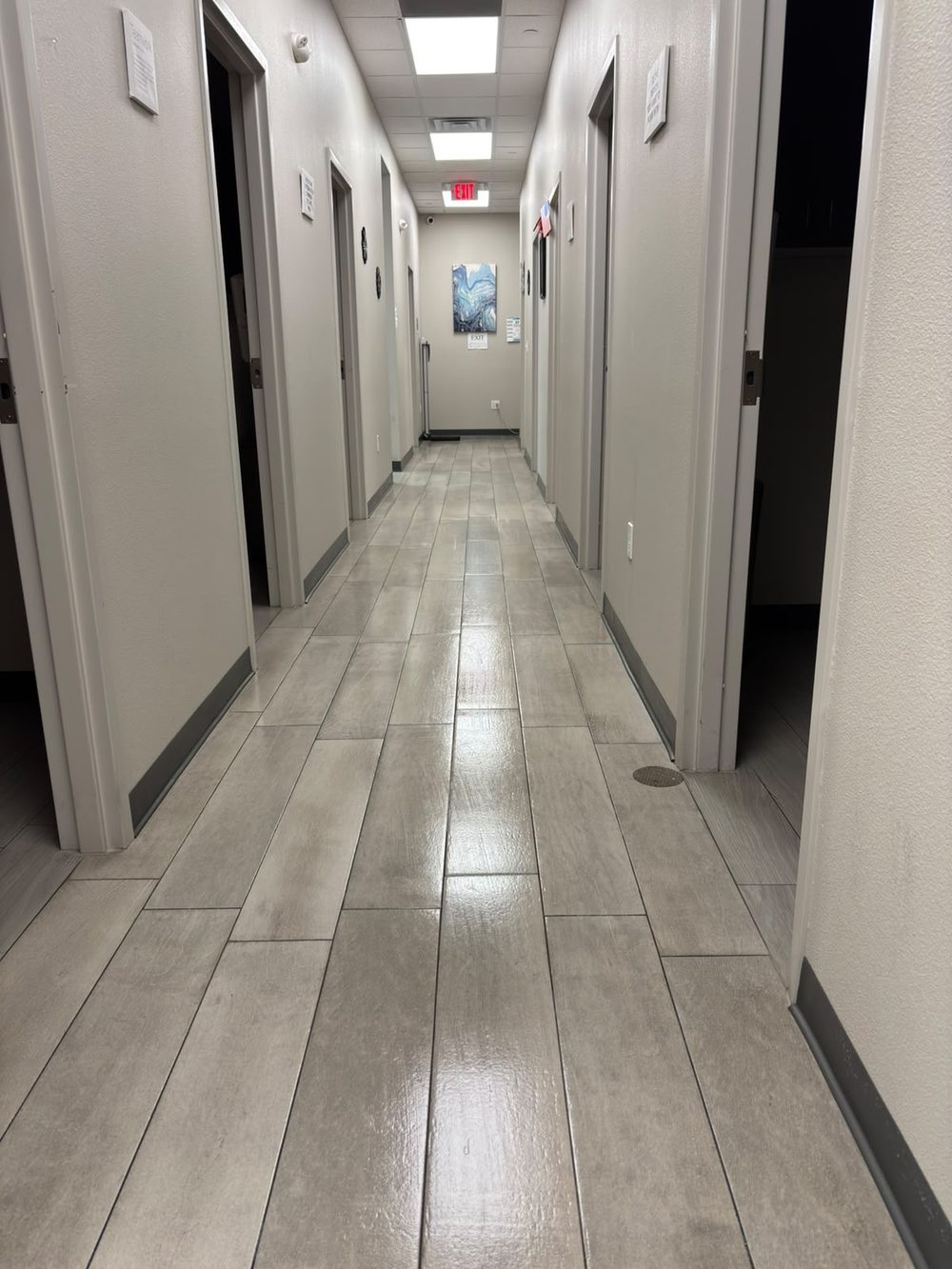 Exam room corridor with light tile flooring cleaned to a clean, even finish